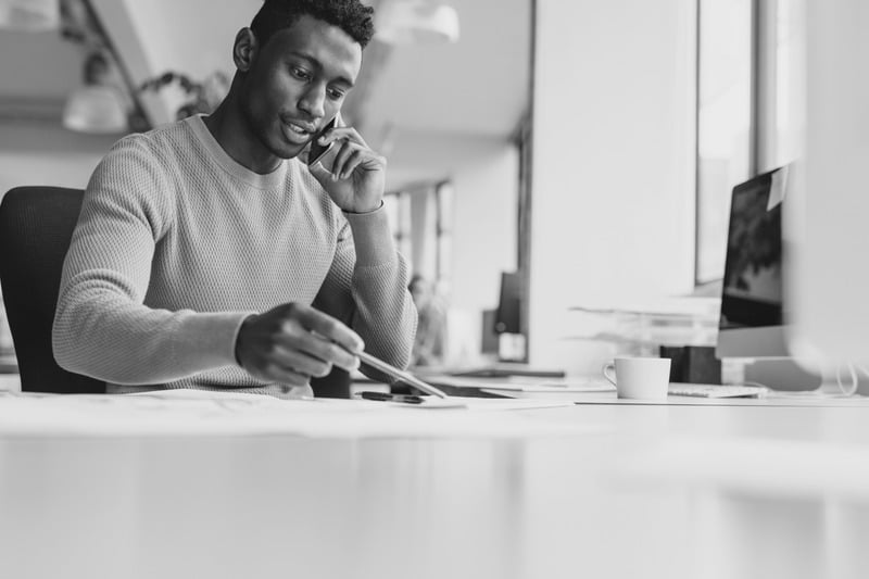 Man talking on the phone at a desk