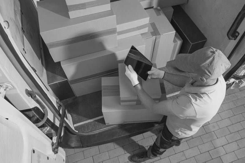 Warehouse worker scanning boxes with a tablet